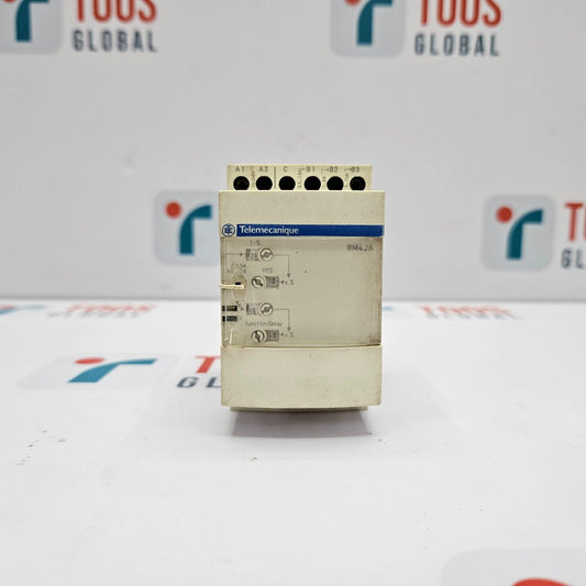 Control panel with Telemecanique branding on a white background with blurred logos.