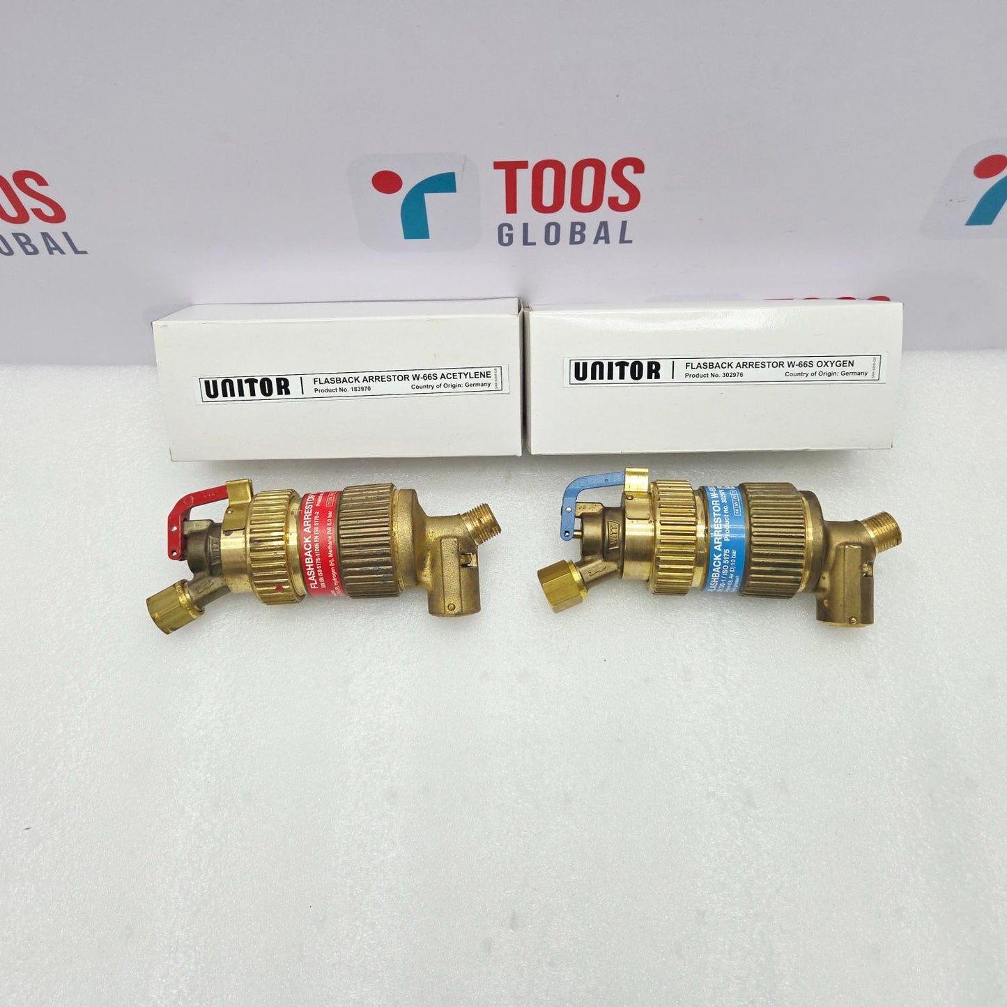 Two brass UNITOR flashback arrestors with their packaging on a white background featuring the 'TOOS GLOBAL' logo.