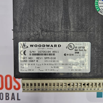 Woodward label on a mechanical component with visible text and symbols.