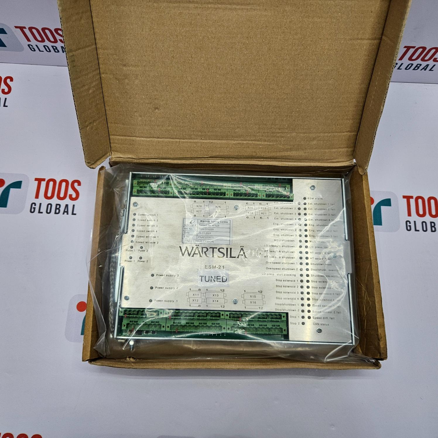 Wartsila ESM-21 Engine Safety Module in a cardboard box with TOOS Global branding in the background.