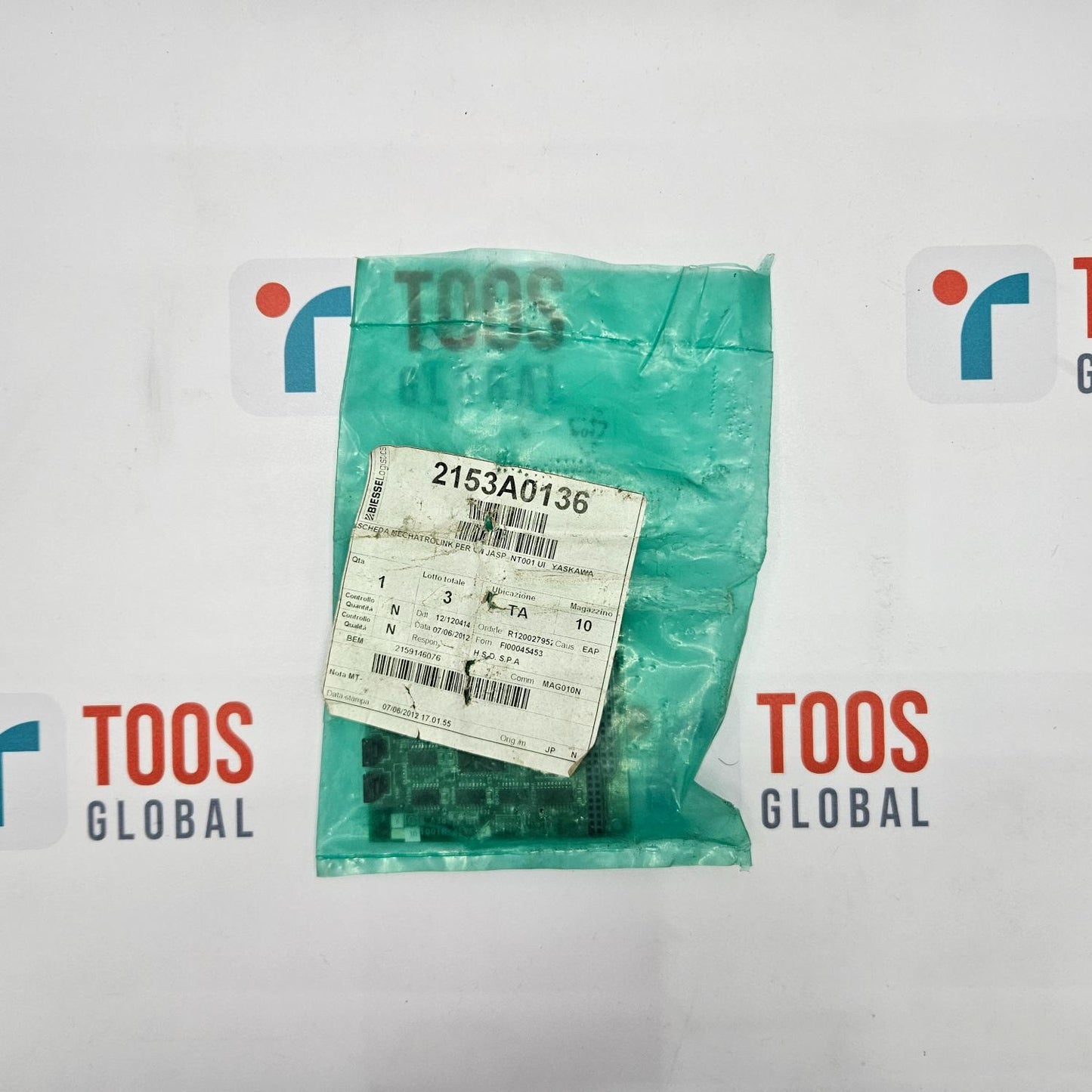 Green plastic bag with a label on a white background featuring 'TOOS GLOBAL' logos.